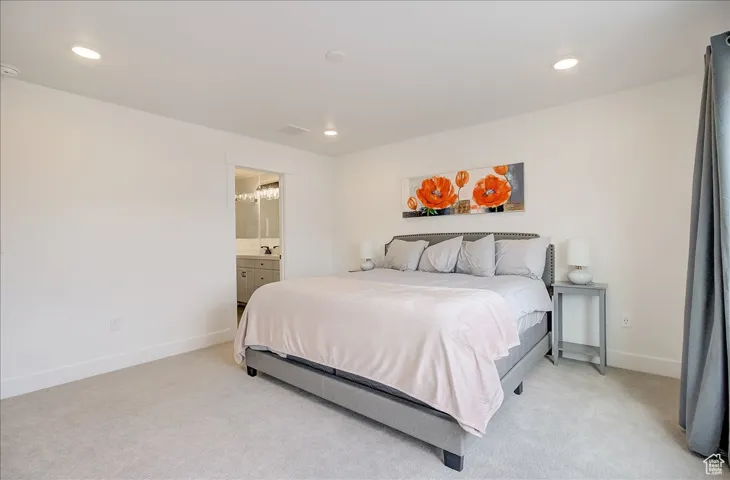 Bedroom featuring carpet floors, recessed lighting, and ensuite bathroom