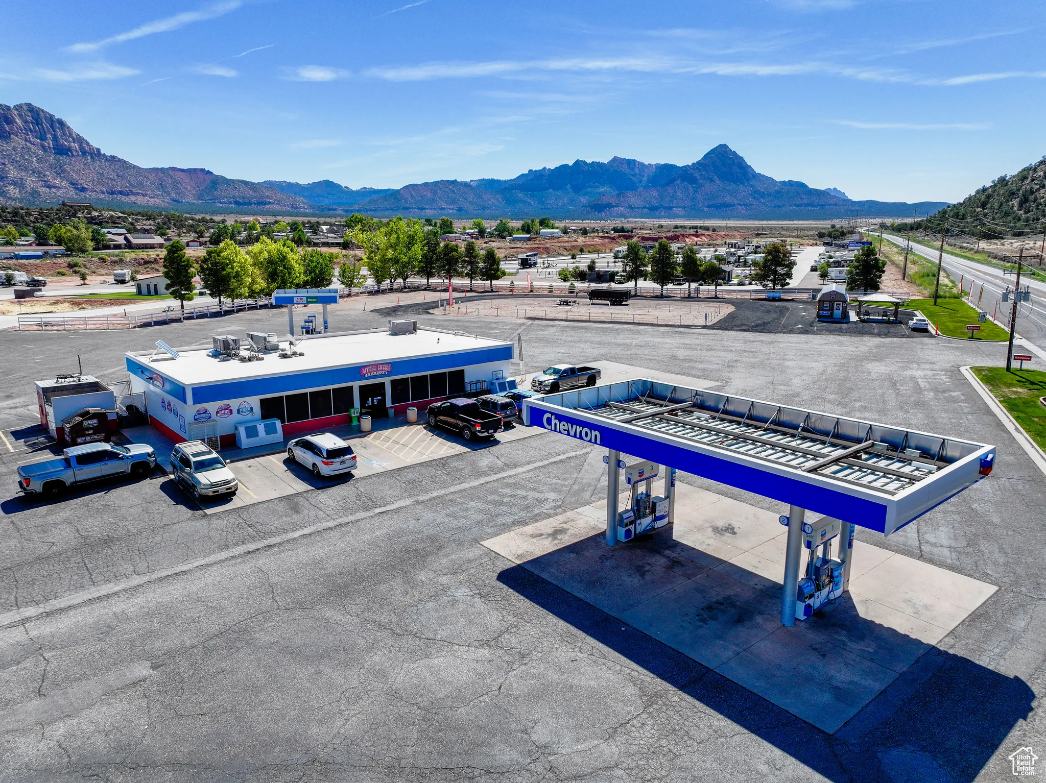 Drone / aerial view of a mountainous background and a commercial area