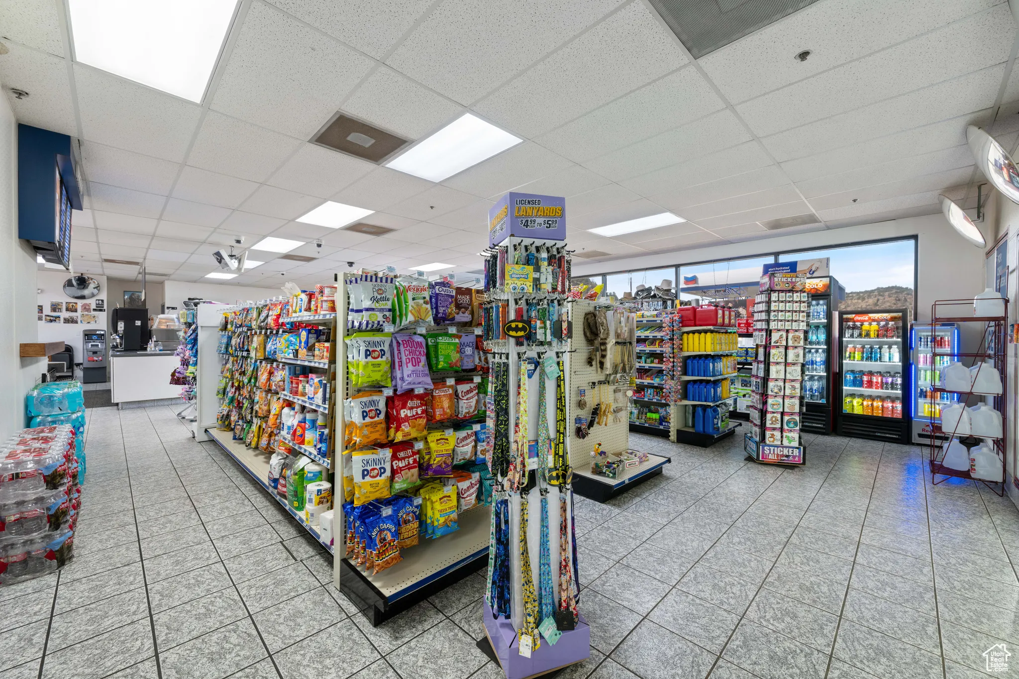 Misc room with light tile patterned floors and a drop ceiling