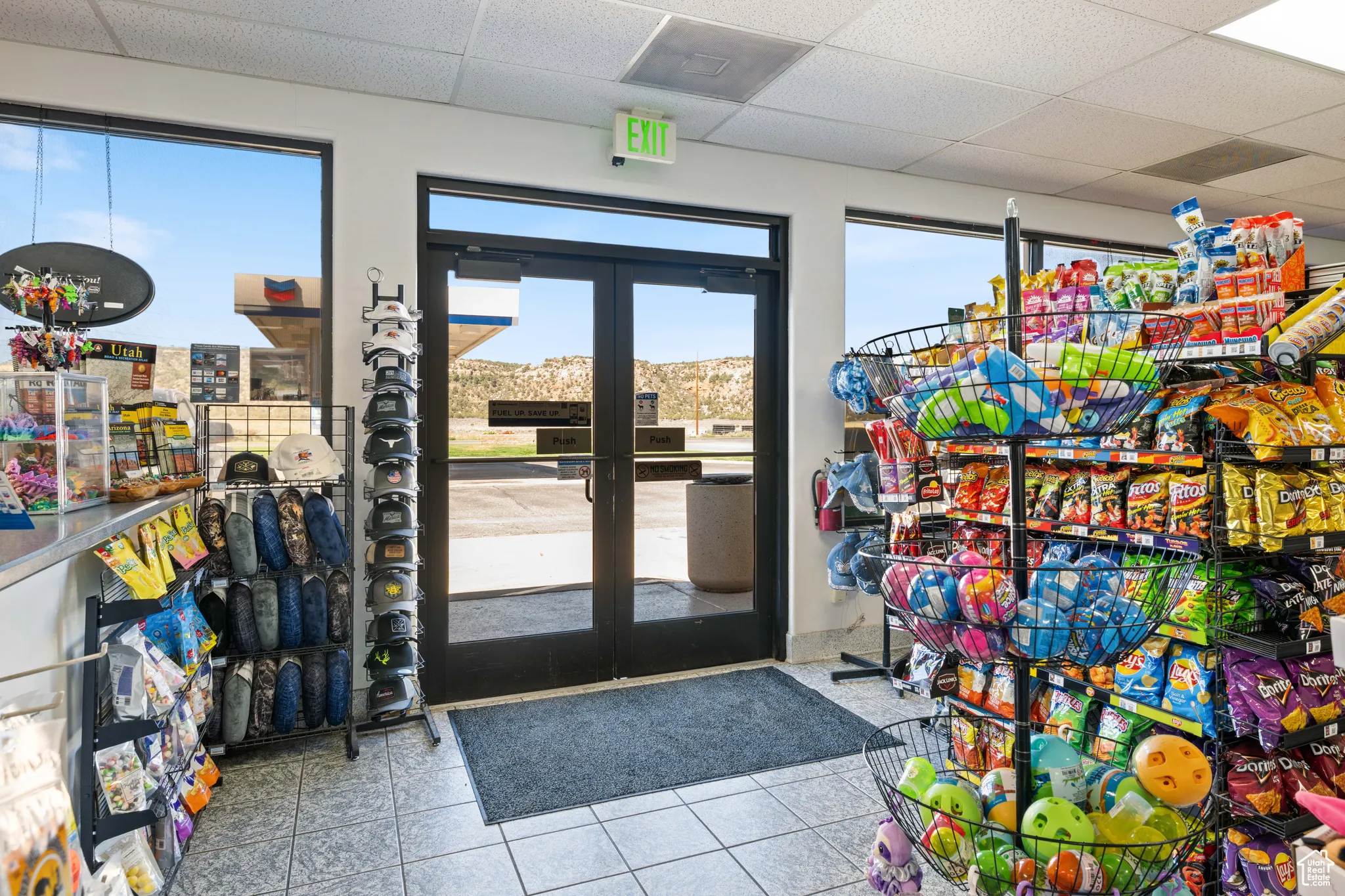 Recreation room featuring a paneled ceiling, tile patterned floors, and french doors