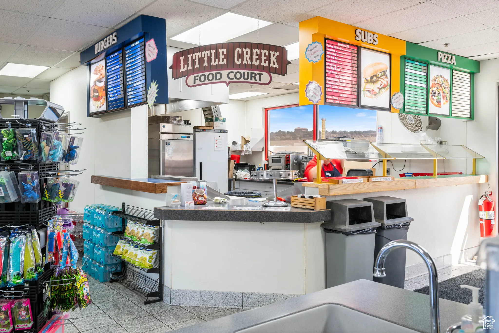 Kitchen with a drop ceiling and light tile patterned floors