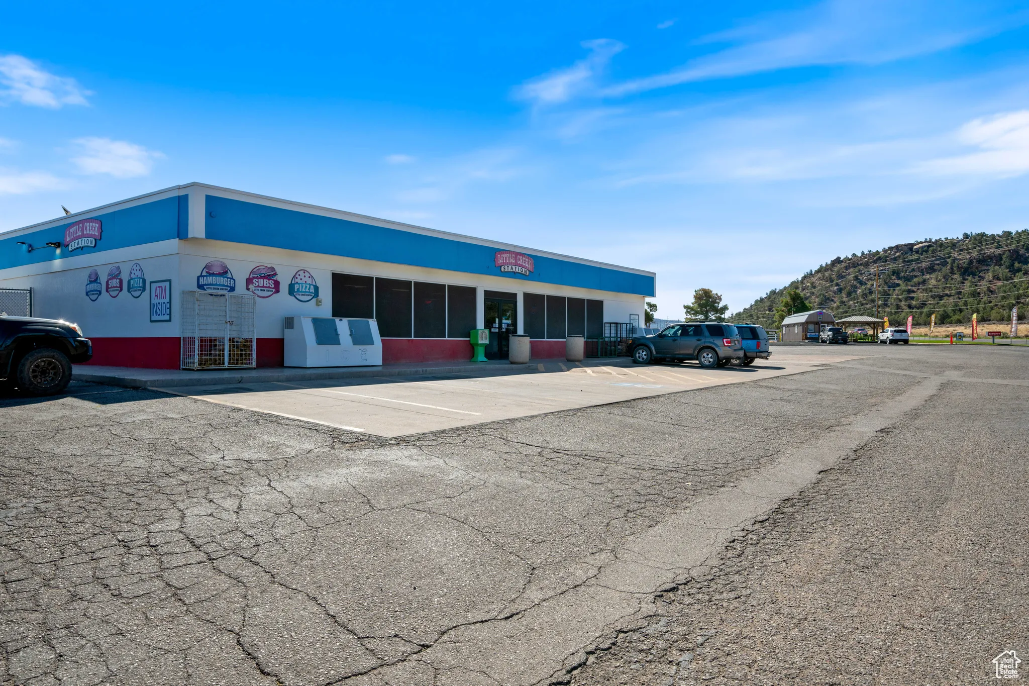 View of commercial property with uncovered parking