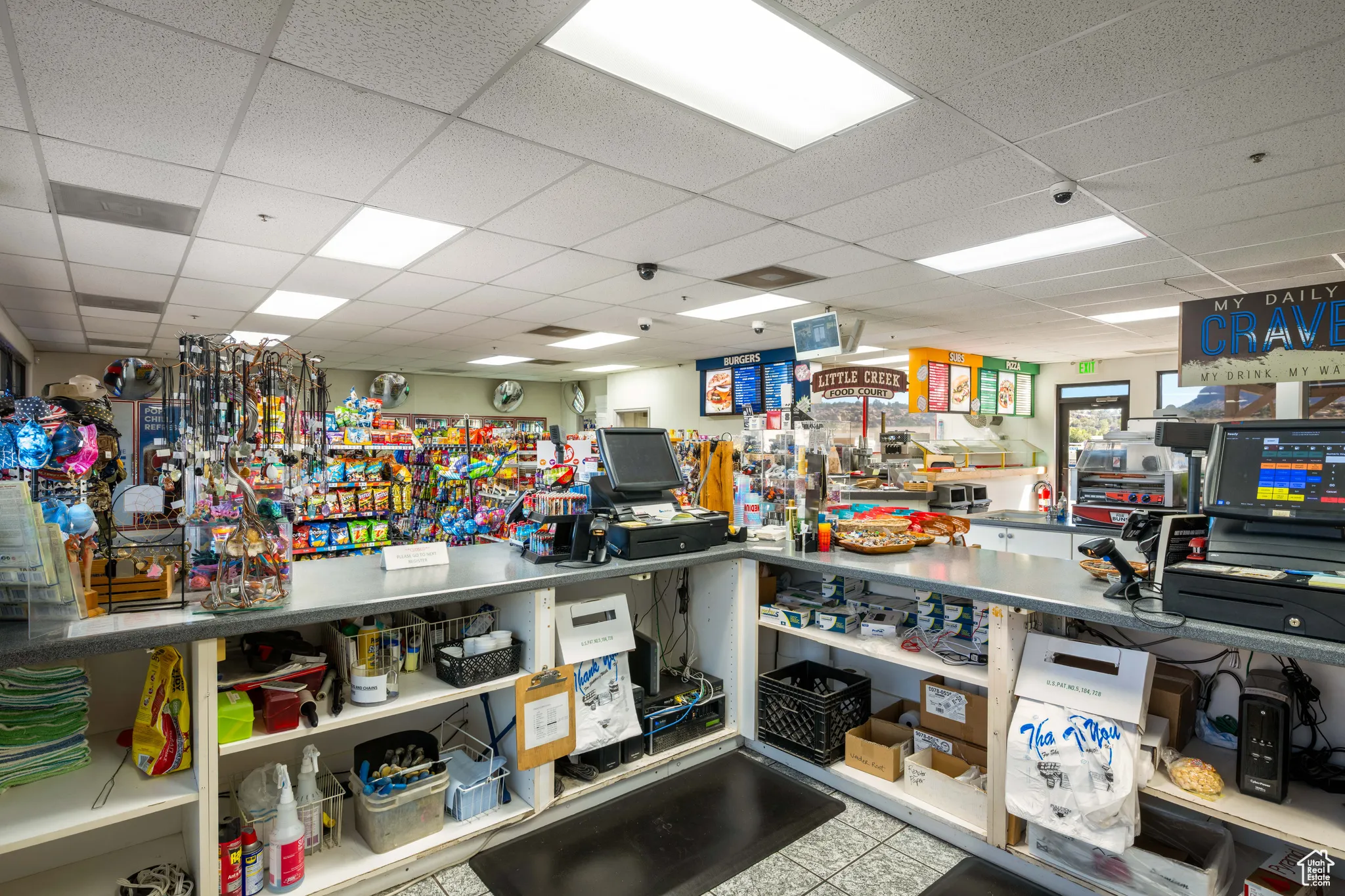Miscellaneous room with a paneled ceiling and light tile patterned floors