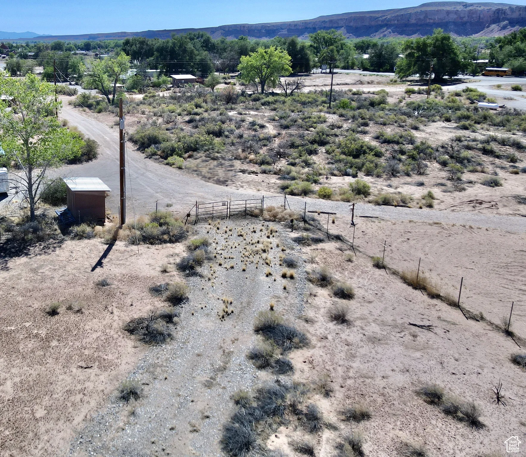 One of two entrances and a road through the lot. Facing east.
