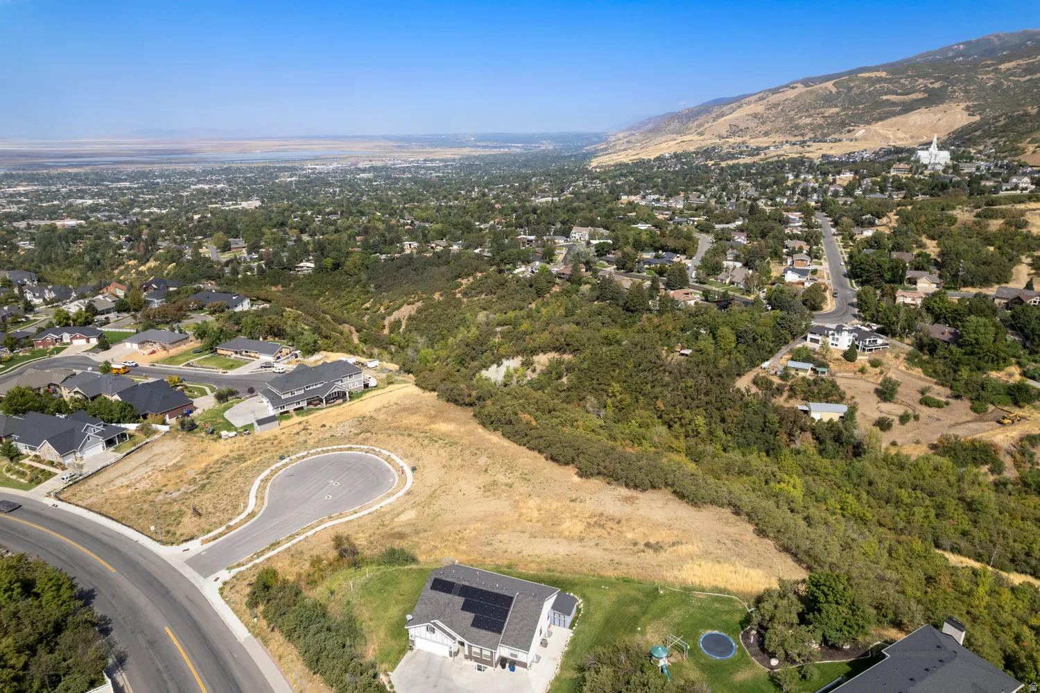 Cleared parcel with existing cul-de-sac and mountain backdrop