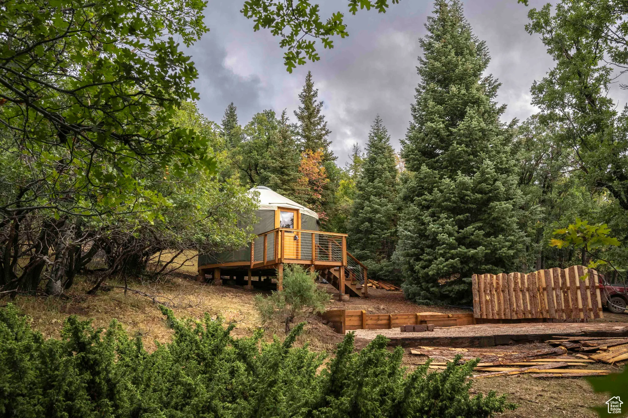 View of yard featuring a deck and a view of trees