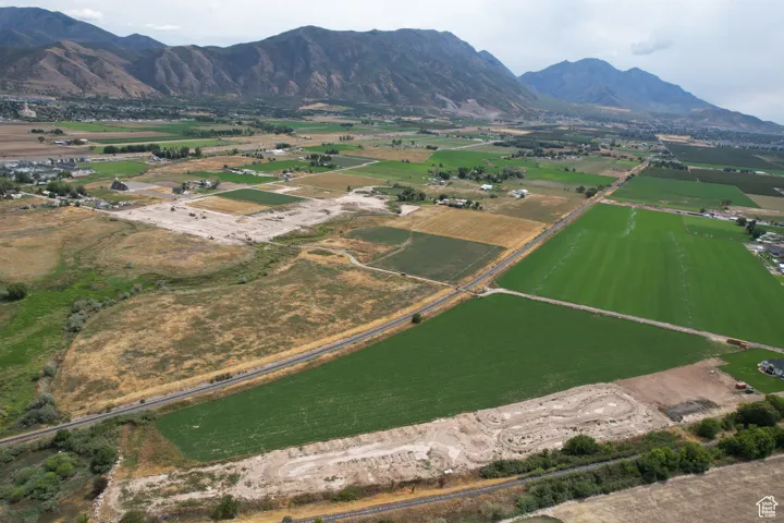 View of property location featuring rural landscape, a mountain backdrop, and farmland