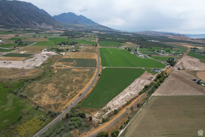 Aerial view of property and surrounding area featuring farmland and rural landscape