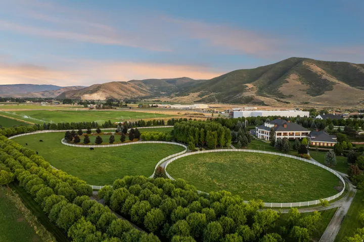 Expansive property featuring multiple fenced pastures and mature tree lines