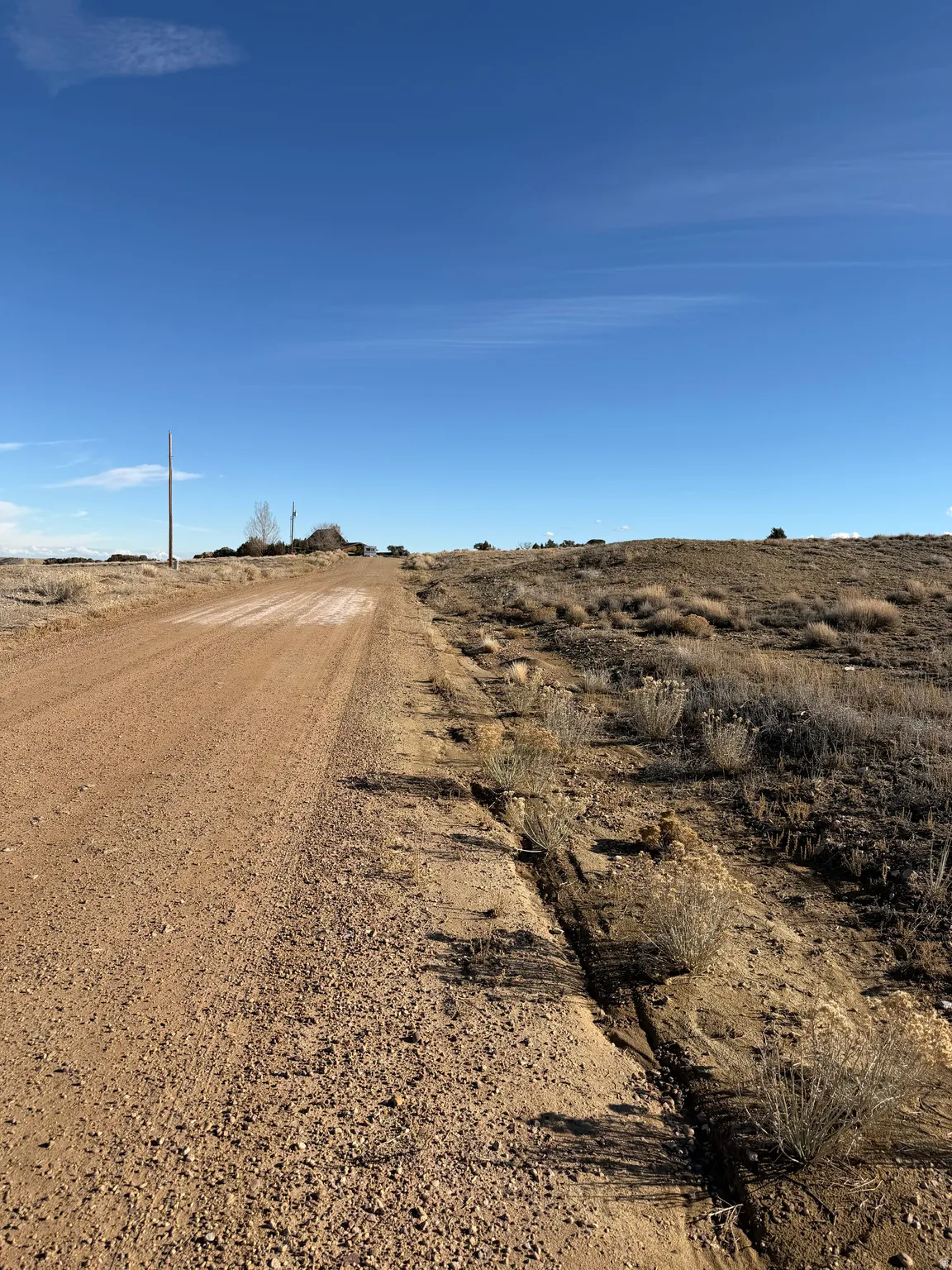 View of dirt / gravel road featuring a view of countryside