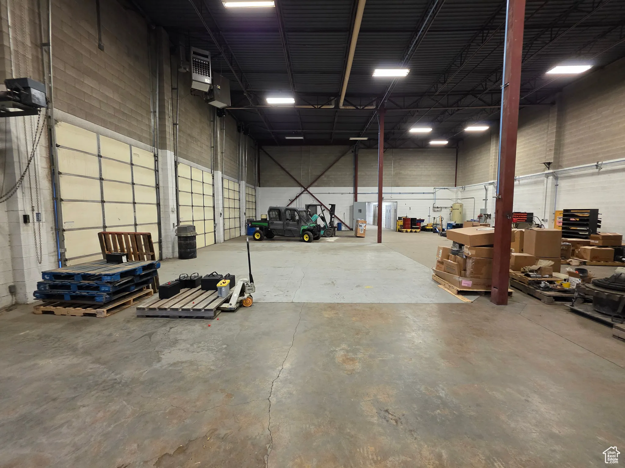 Garage featuring a heating unit and a garage door opener