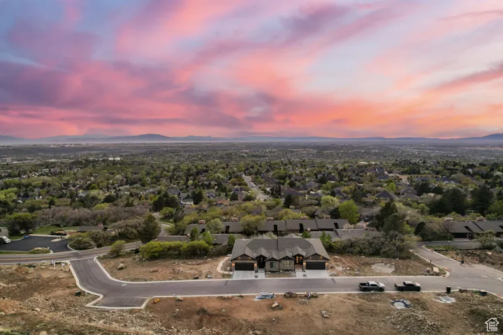 Aerial view of property's location featuring a mountainous background and nearby suburban area