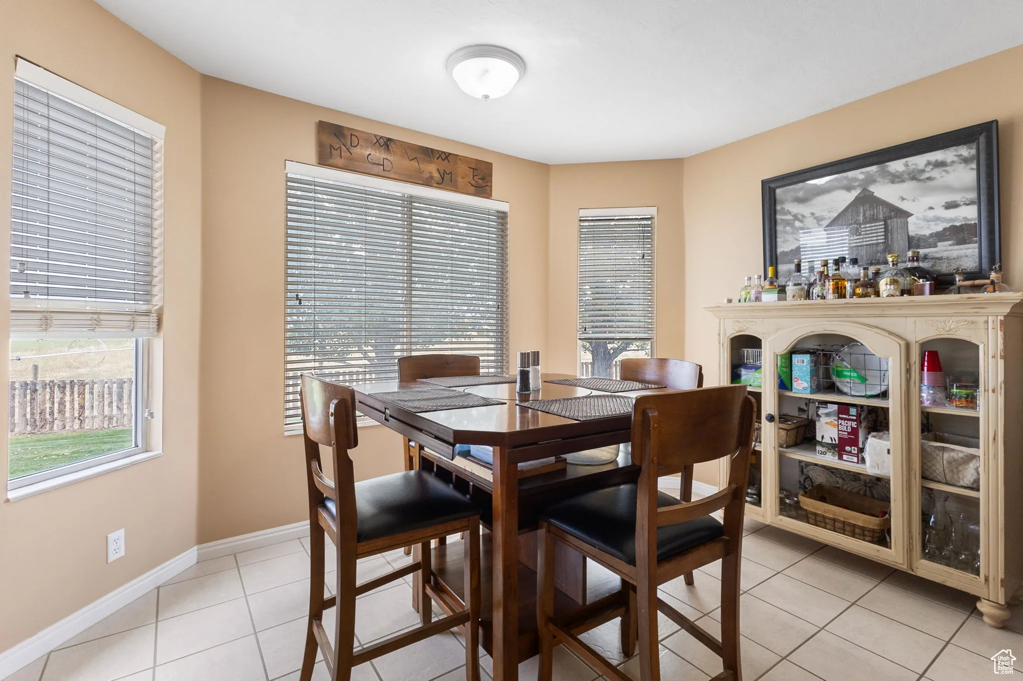 Dining space with light tile patterned flooring