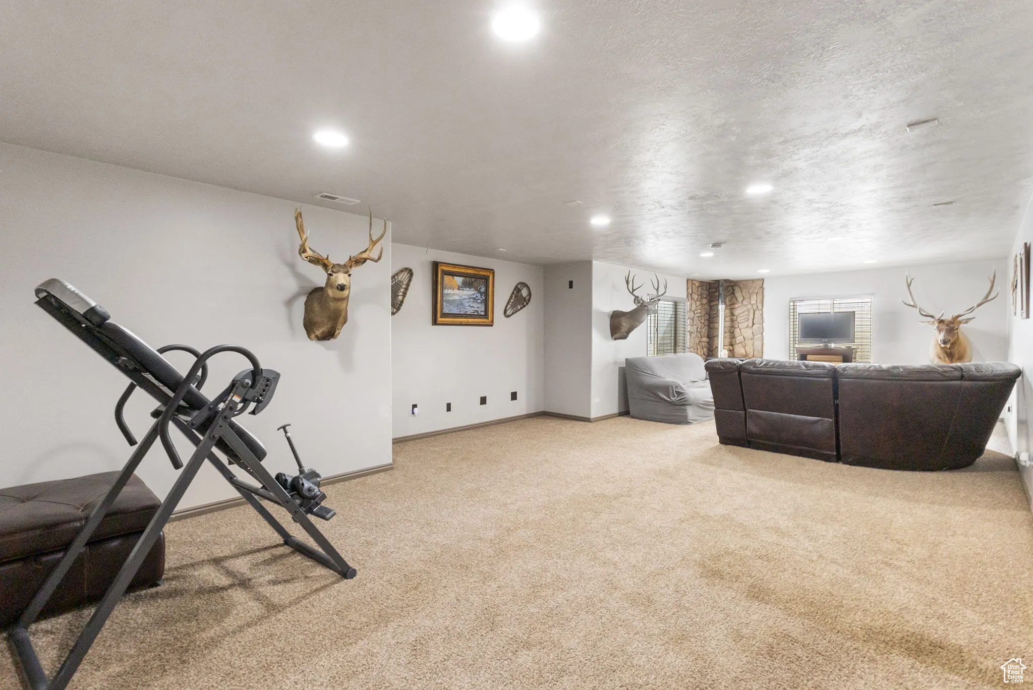 Workout area featuring light colored carpet and recessed lighting