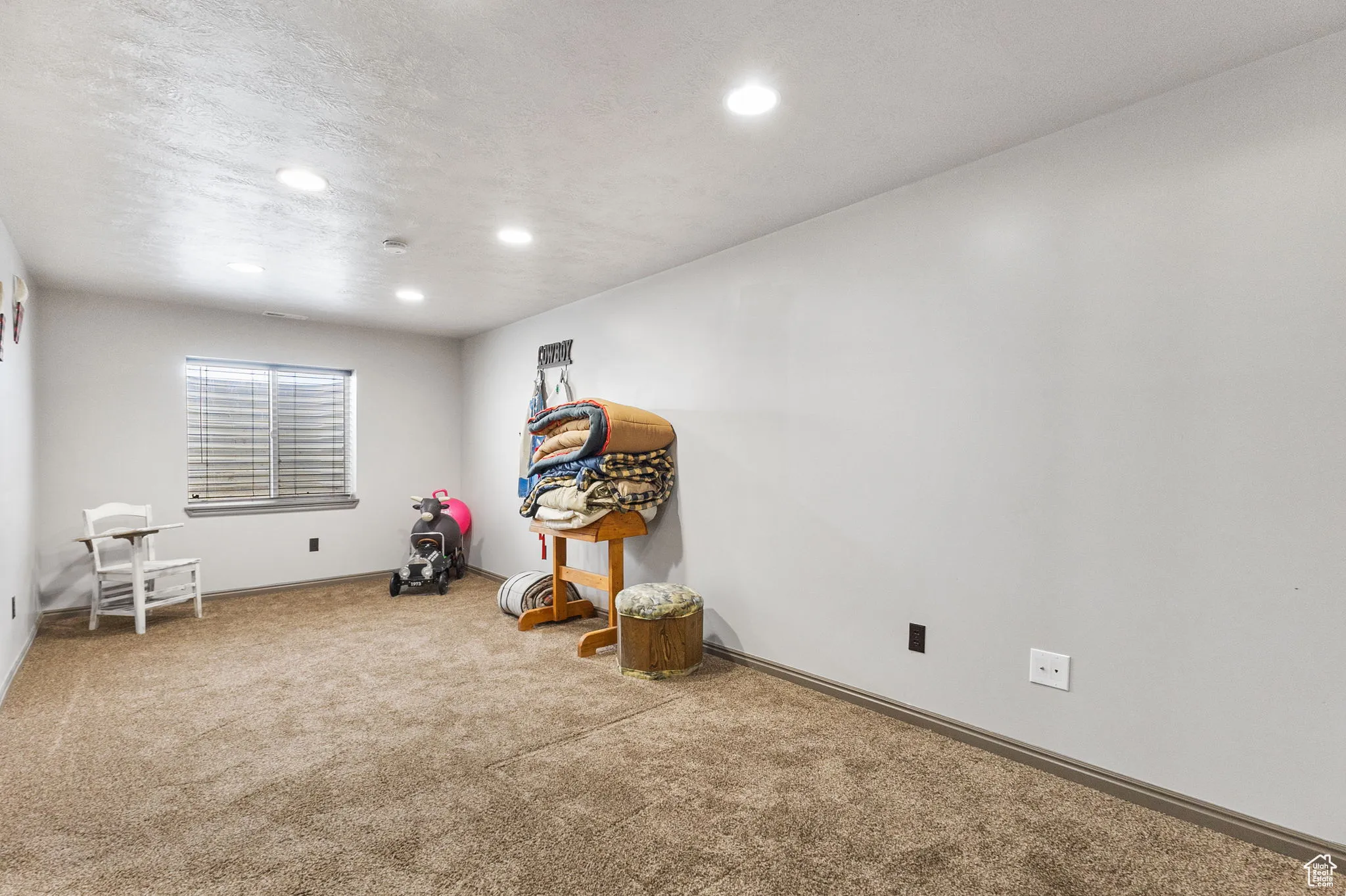 Unfurnished room with carpet floors, recessed lighting, and a textured ceiling