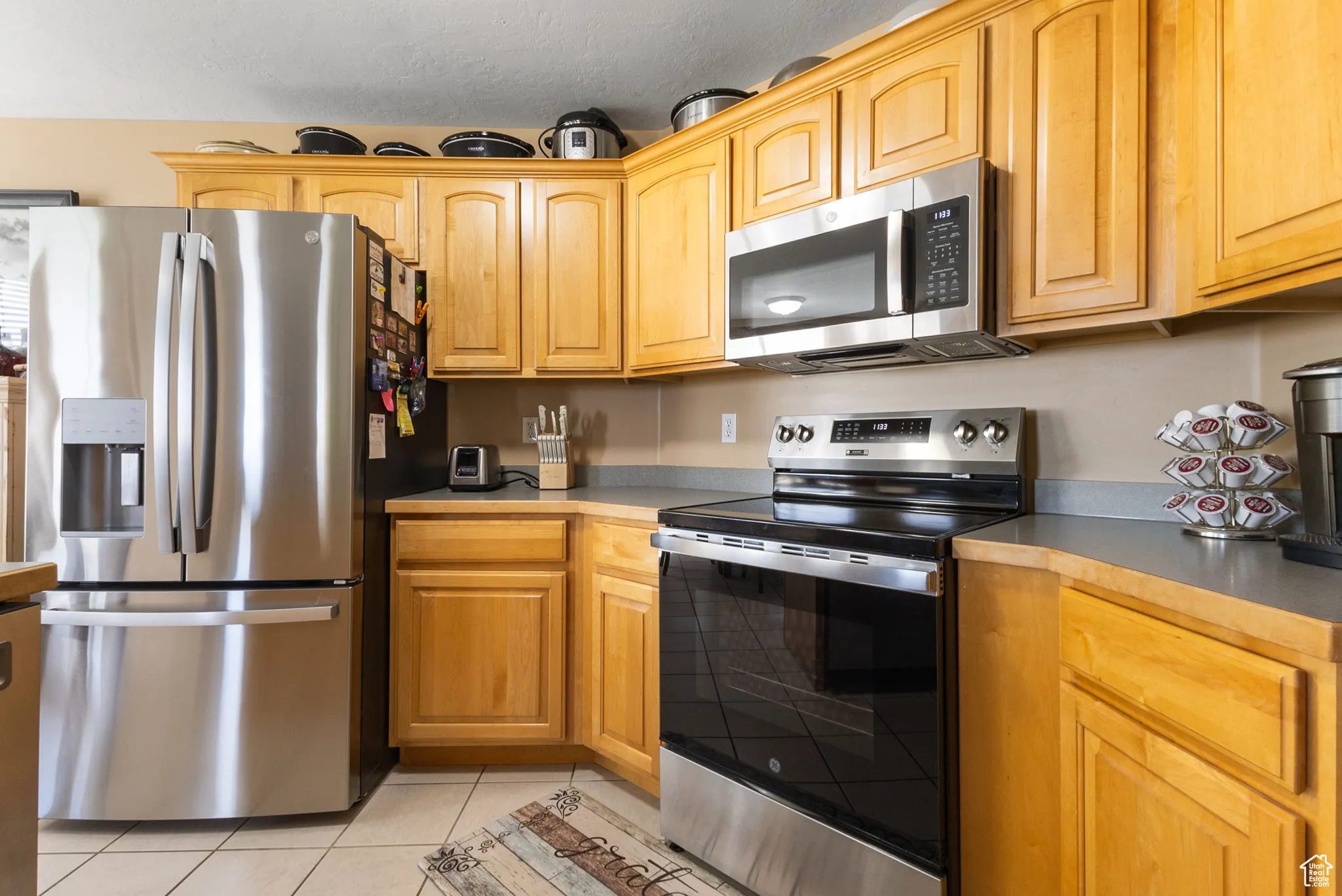 Kitchen with stainless steel appliances and light tile patterned floors