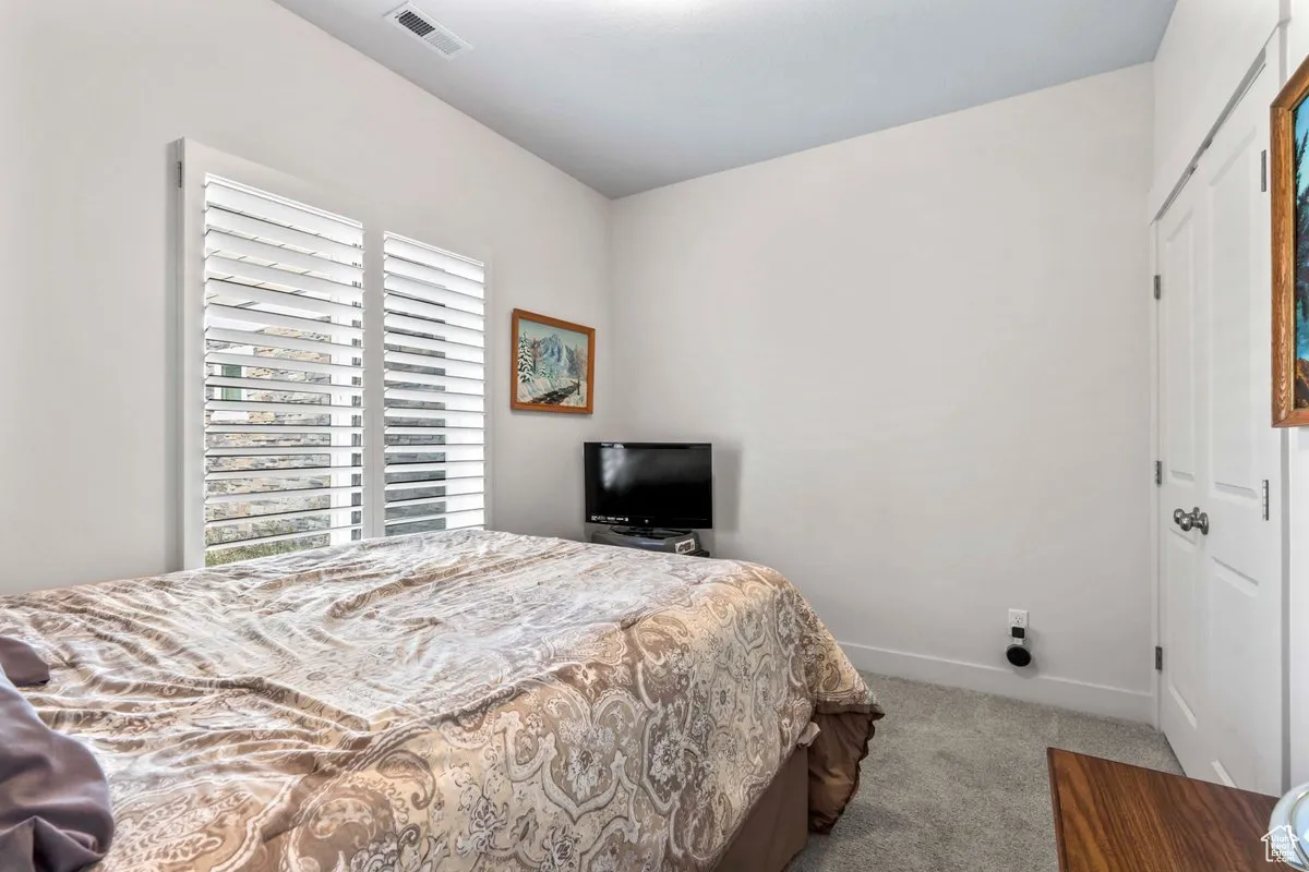 Bedroom with carpet flooring and a closet