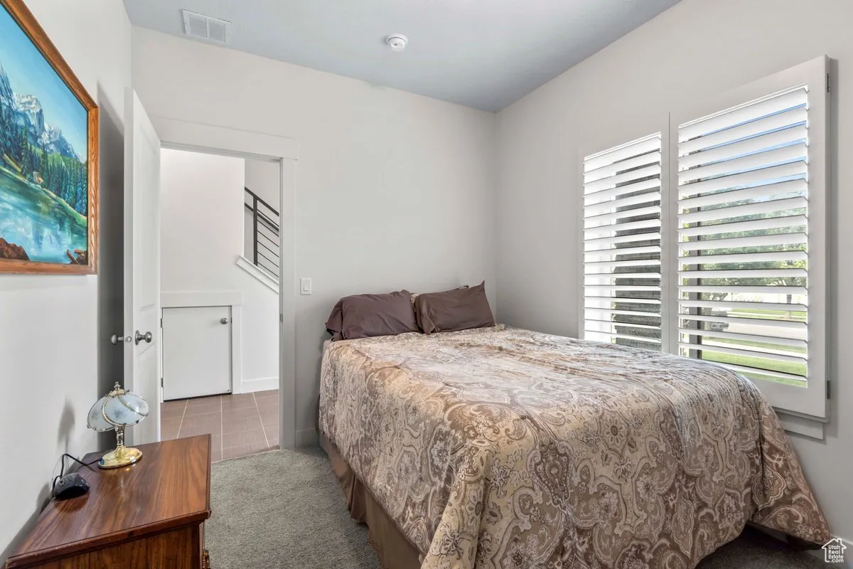 Tiled bedroom with carpet floors and baseboards