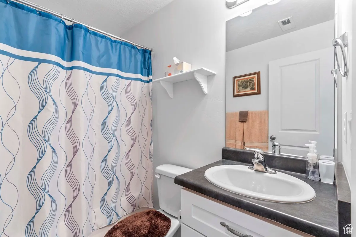 Full bathroom with vanity and a shower with curtain