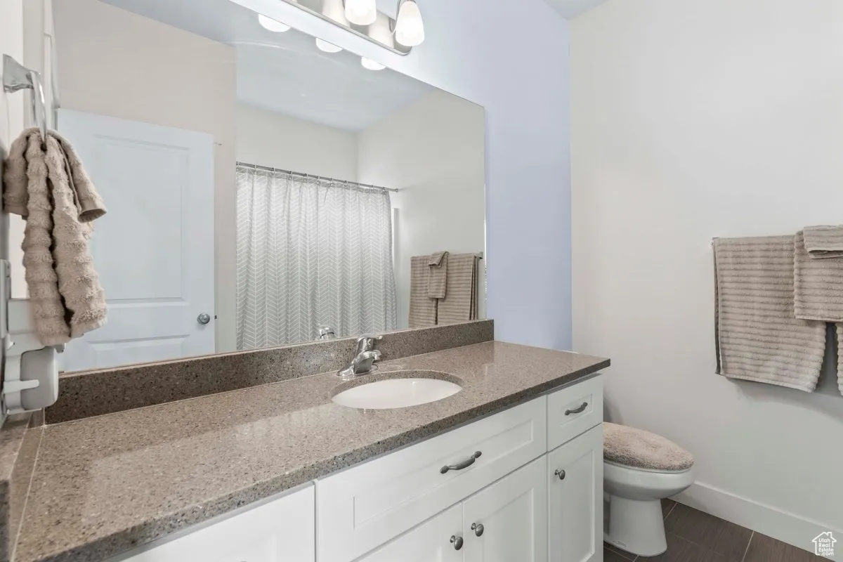Full bathroom with vanity and a shower with shower curtain