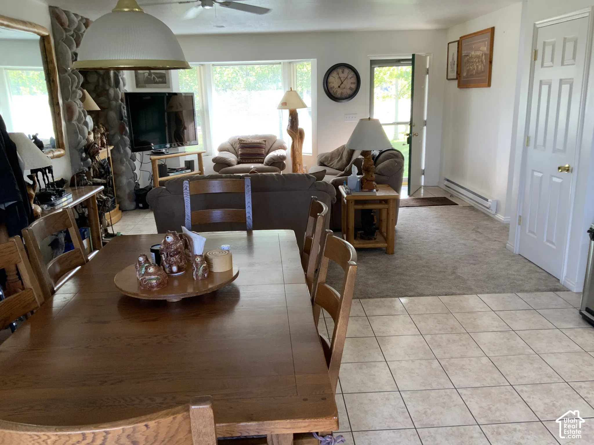 Mixed flooring featuring neutral-toned tile and carpet
