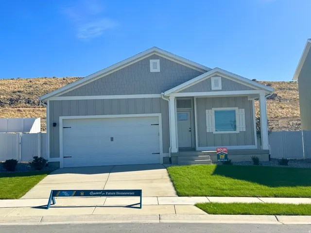 View of front of house with a garage, board and batten siding, concrete driveway, and covered porch