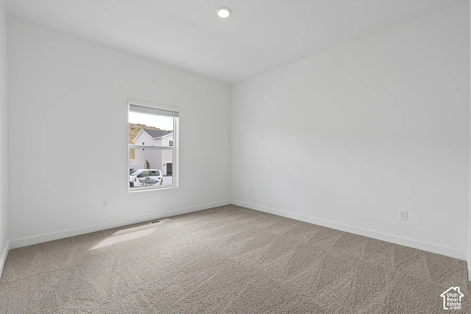 Unfurnished room featuring light colored carpet and recessed lighting