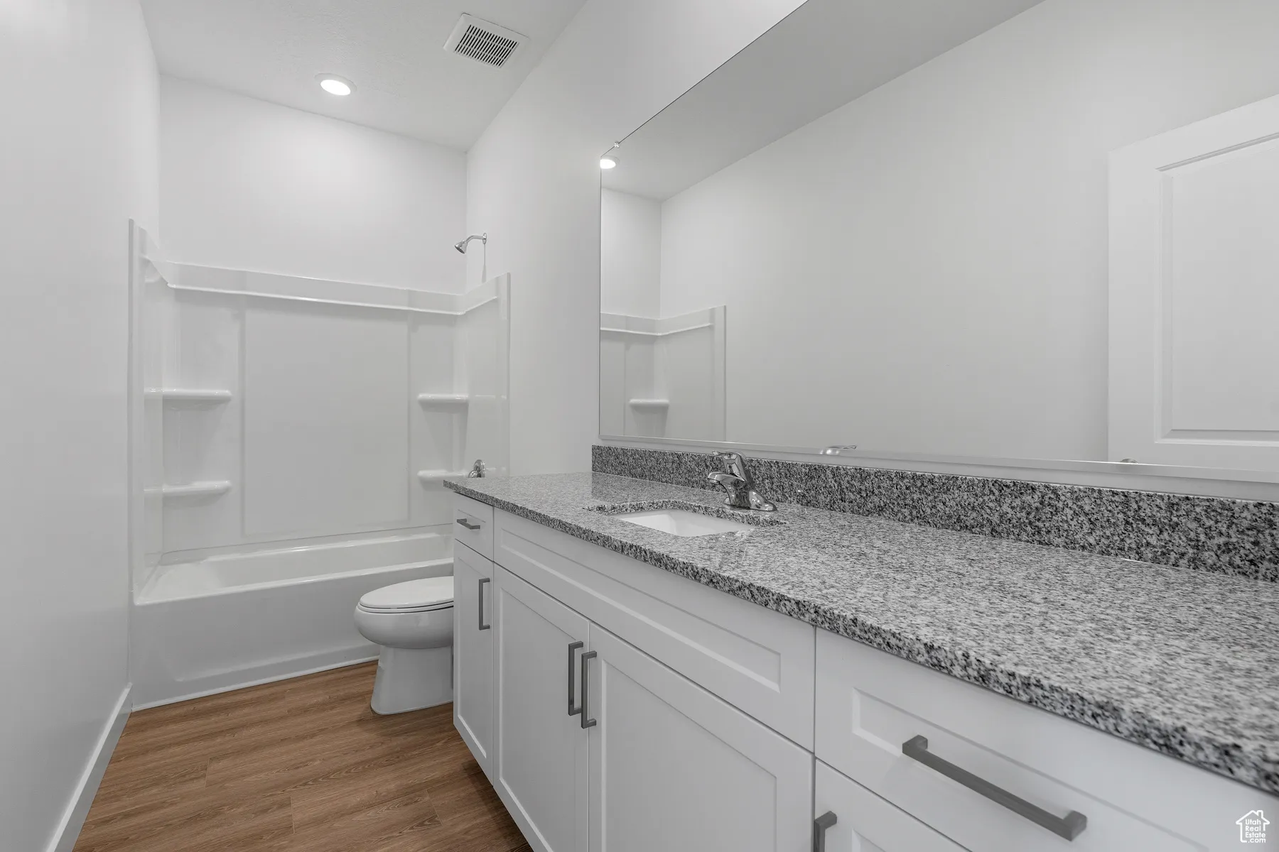 Bathroom with  shower combination, vanity, and dark wood-style floors
