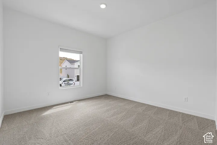 Unfurnished room featuring light colored carpet and recessed lighting