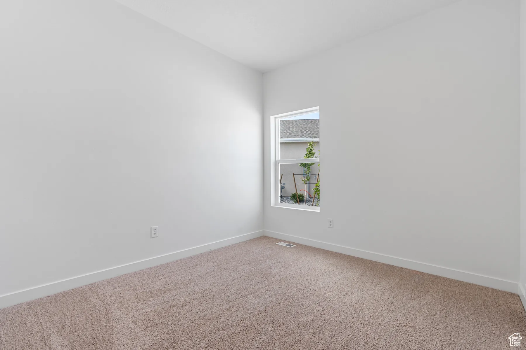 Unfurnished room featuring carpet and baseboards