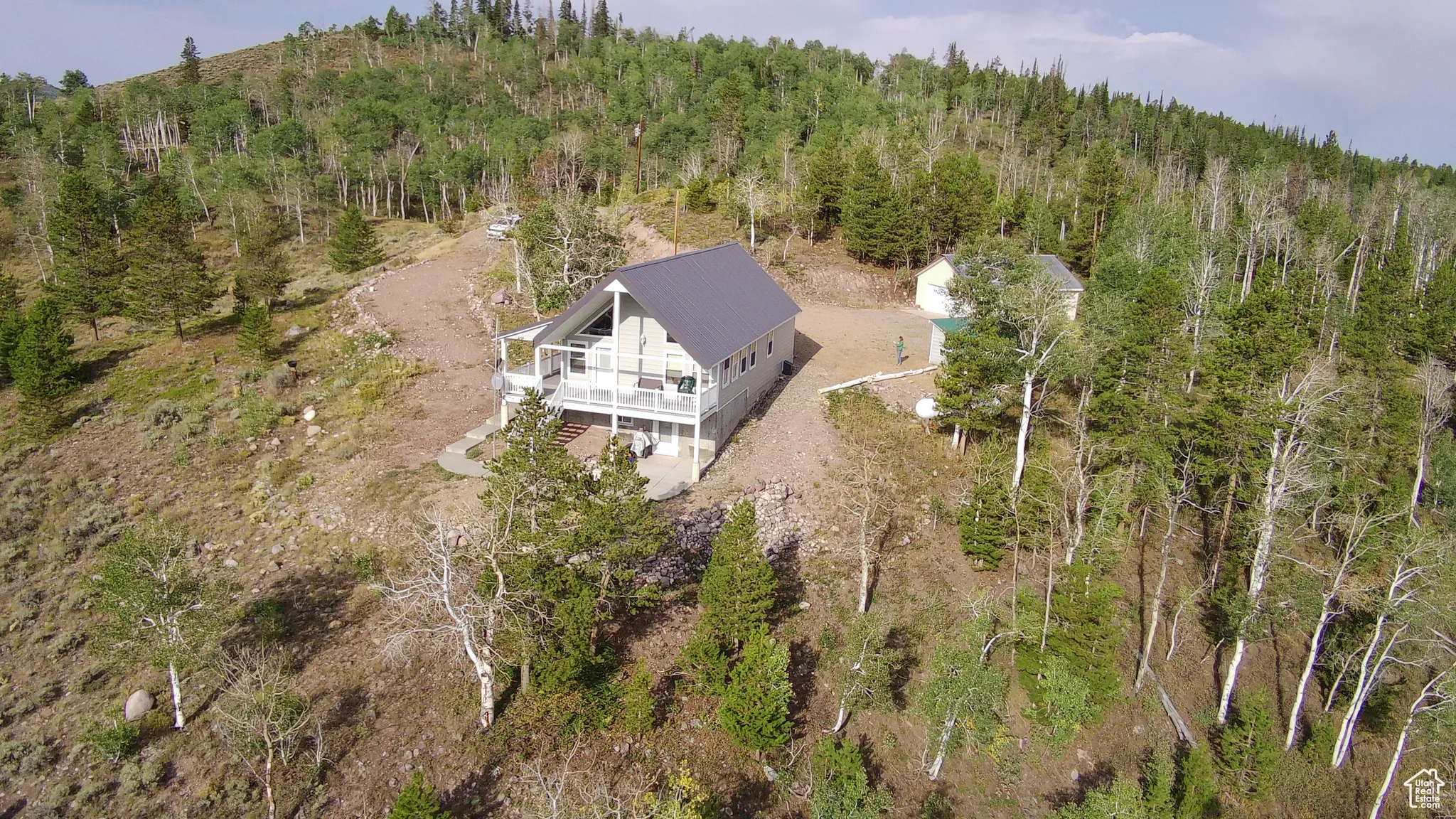 Aerial overview of property's location featuring a forest
