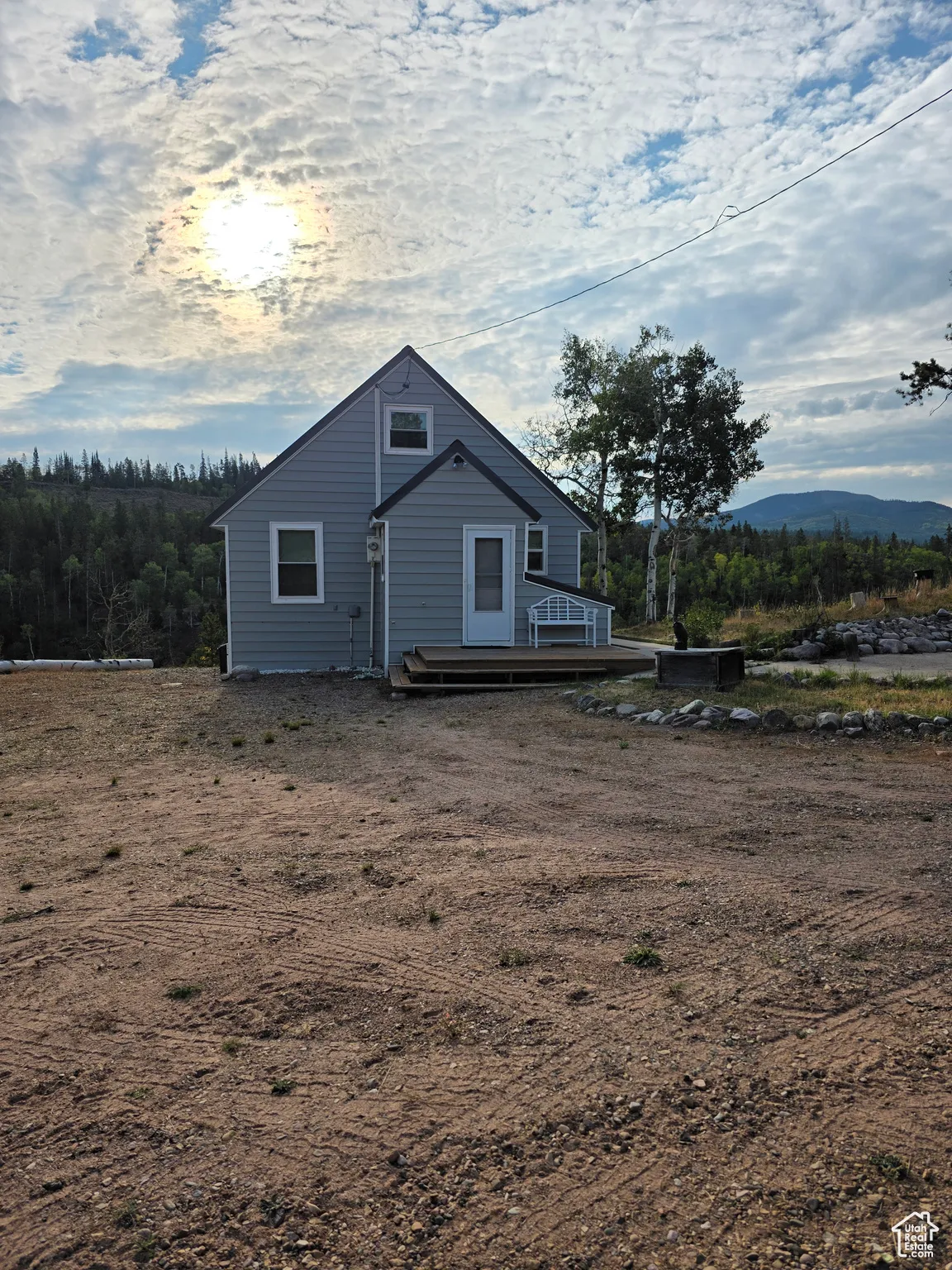 View of side of home featuring a wooden deck