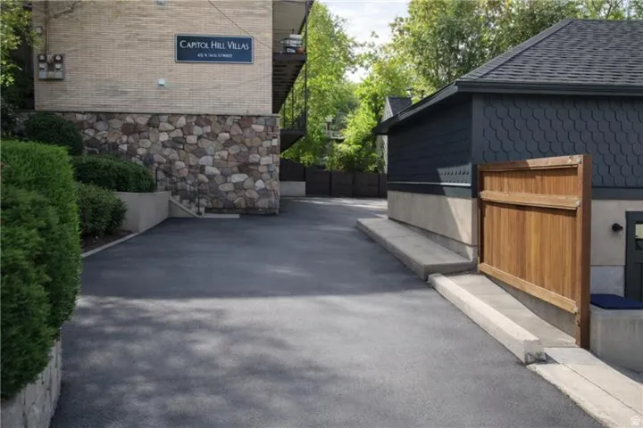 View of side of home featuring roof with shingles