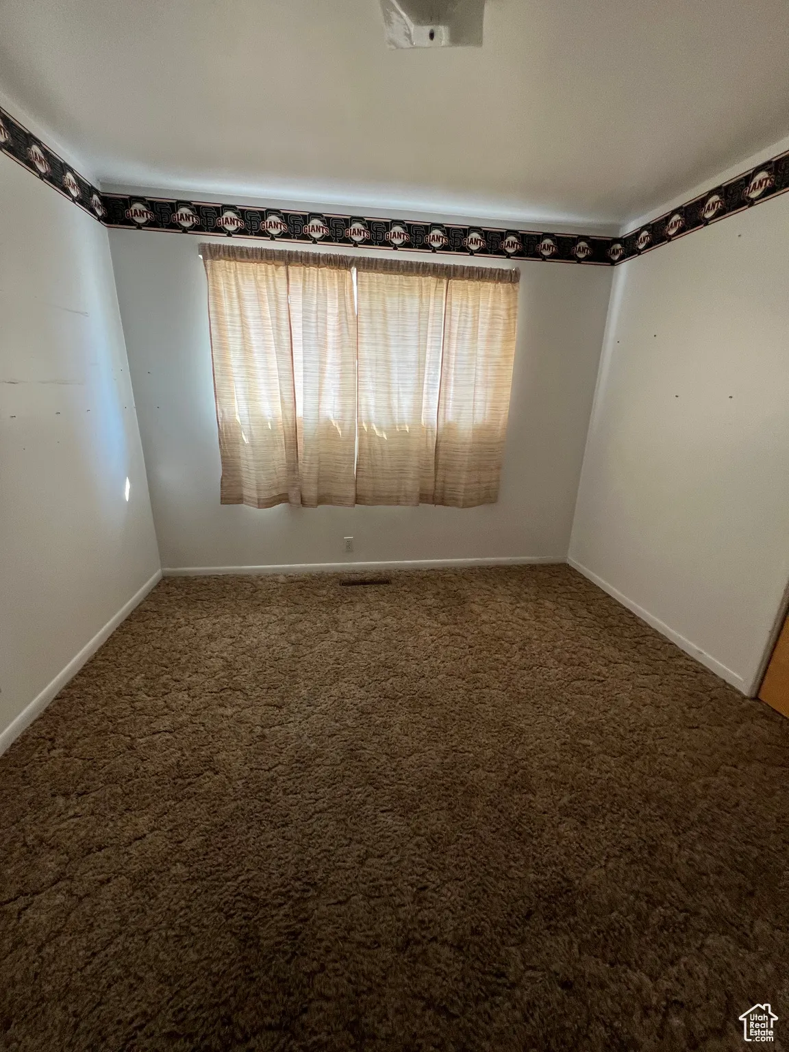 Unfurnished room with carpet floors and baseboards