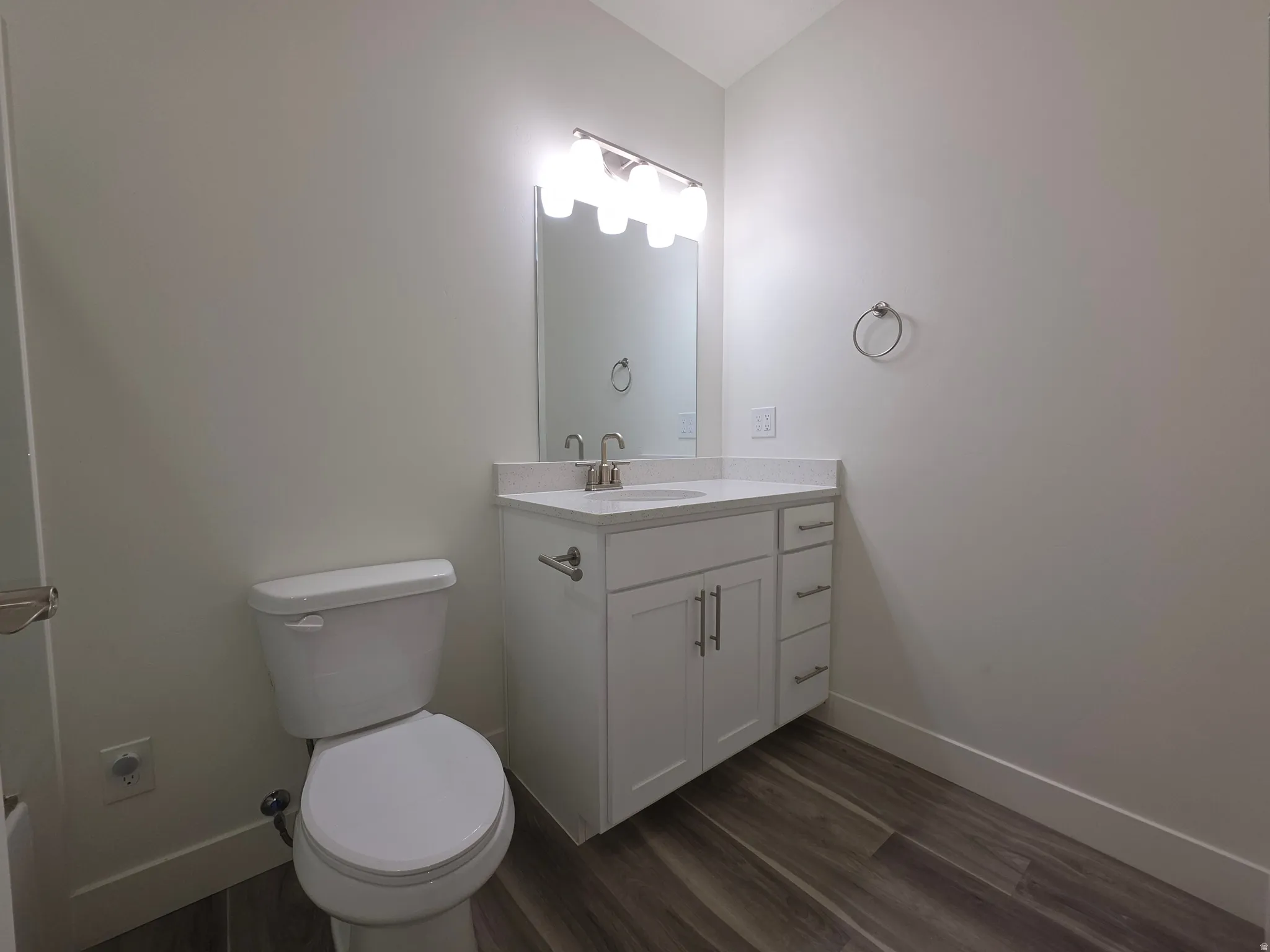 Bathroom featuring vanity and dark wood-type flooring