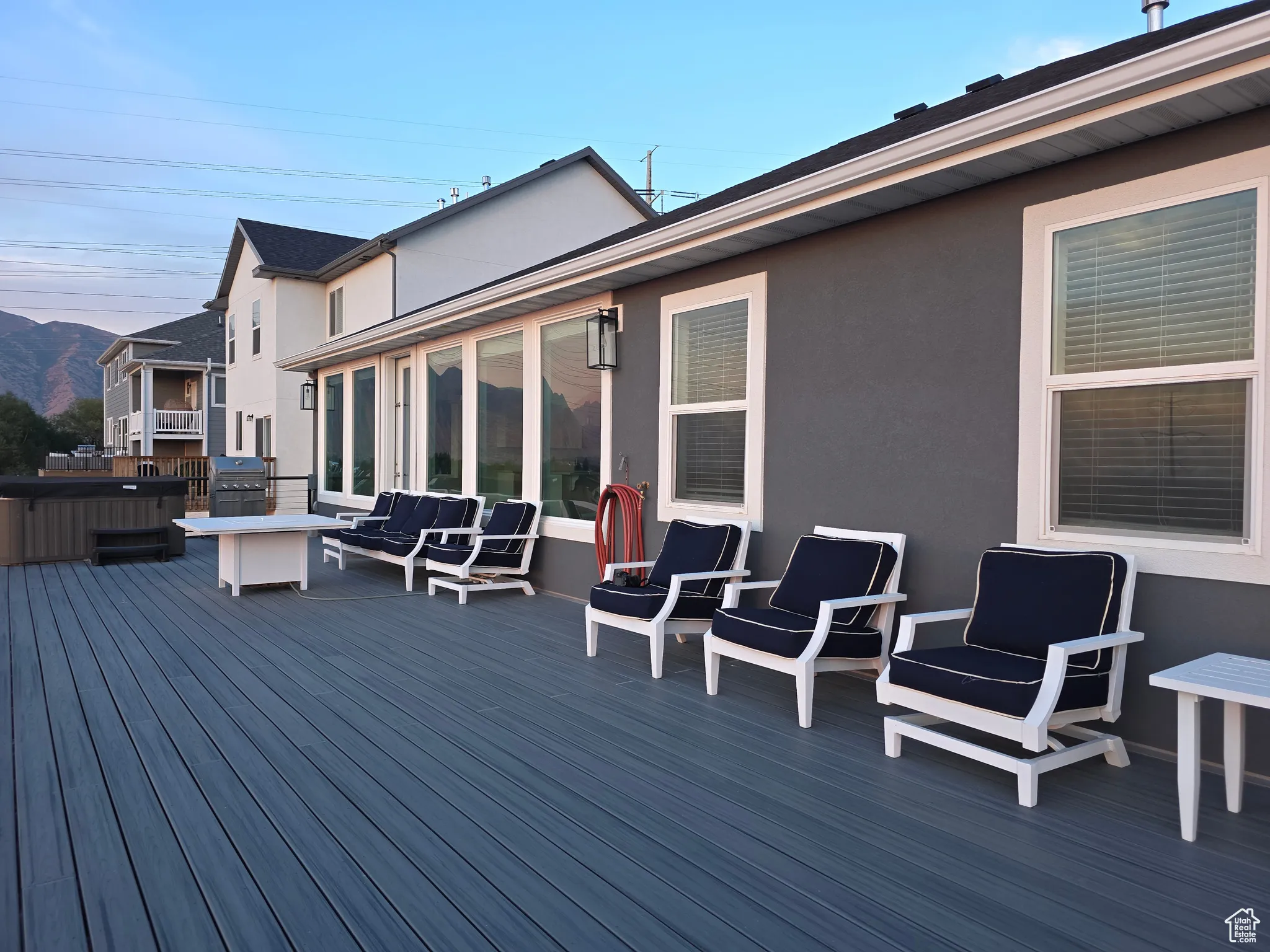 Wooden terrace featuring a mountain view, area for grilling, and an outdoor hangout area
