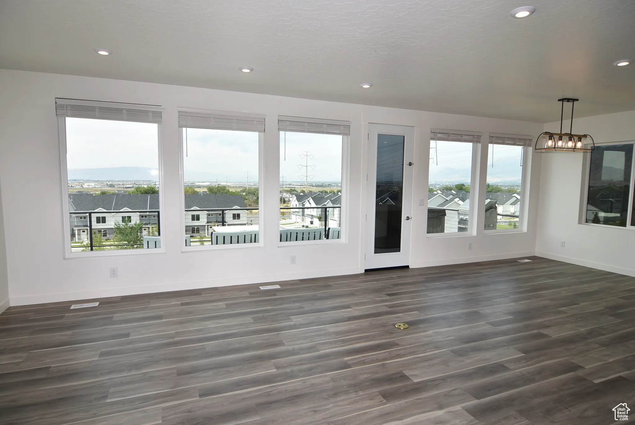 Great room and dining area with view windows and door leading to back deck