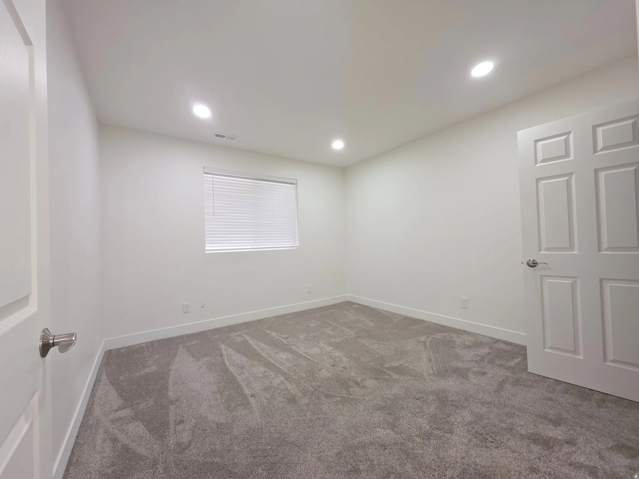 Unfurnished room with carpet and recessed lighting