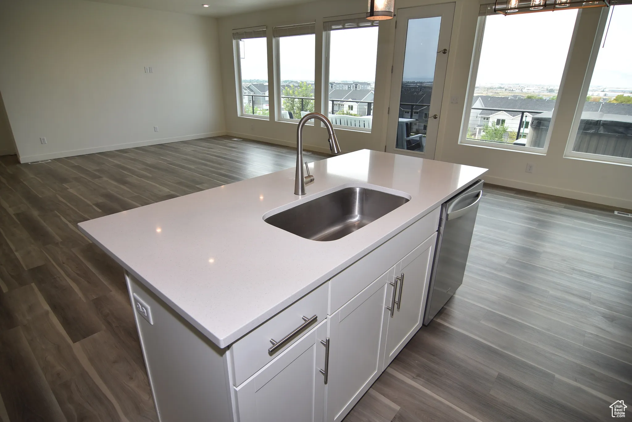 Kitchen featuring an island with sink and dishwasher.