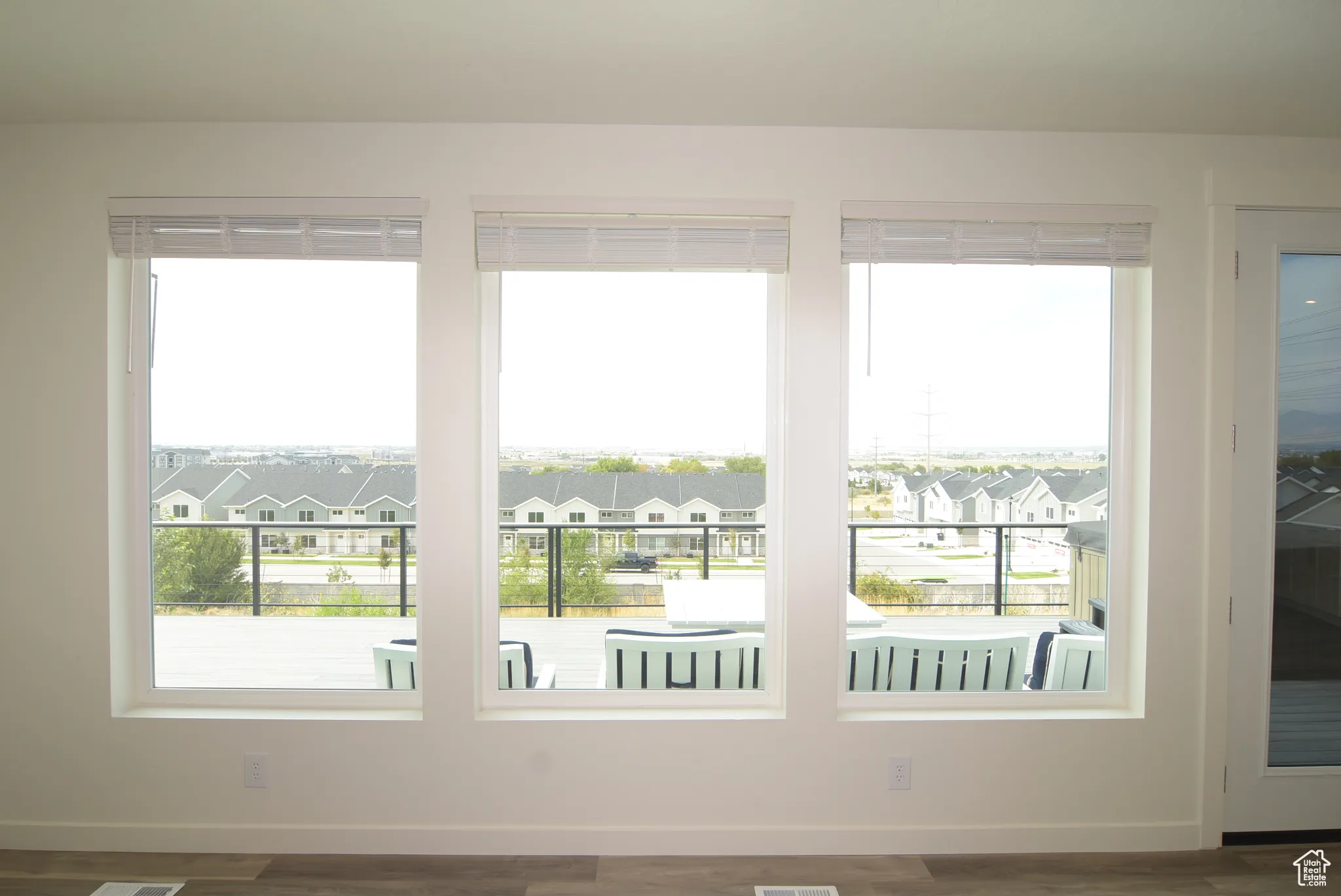 Entryway featuring a residential view, plenty of natural light, and wood finished floors