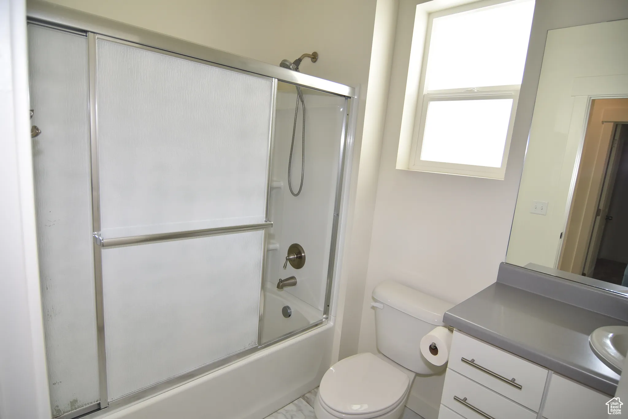 Bathroom #2 featuring enclosed tub / shower combo and vanity