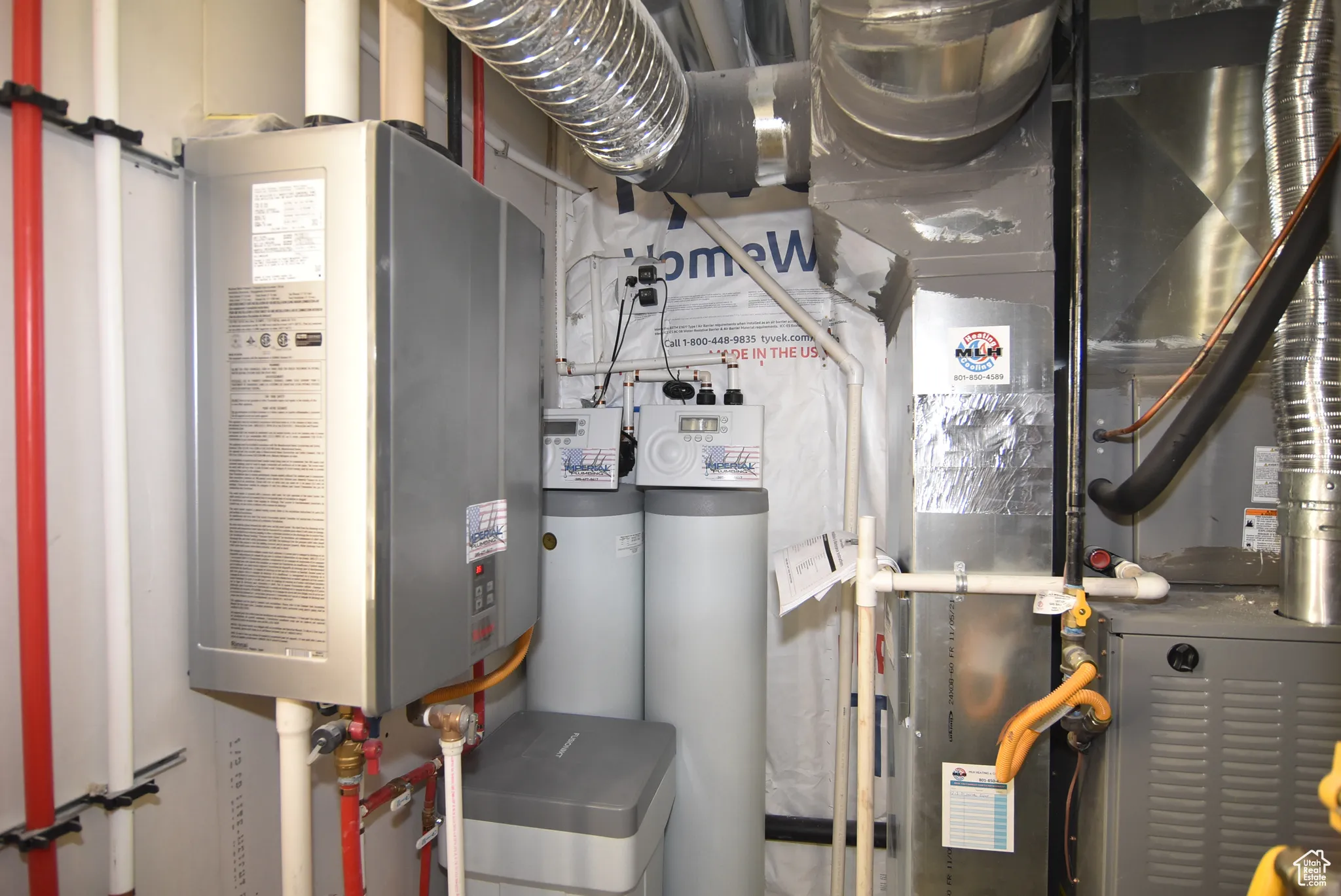Utility room with tankless water heater and heating unit