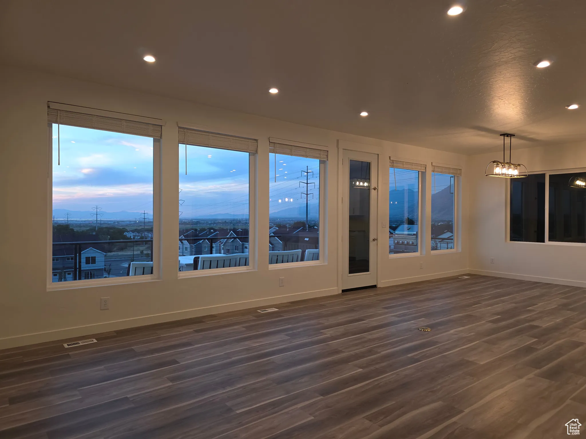 Spare room featuring dark wood-style floors and recessed lighting