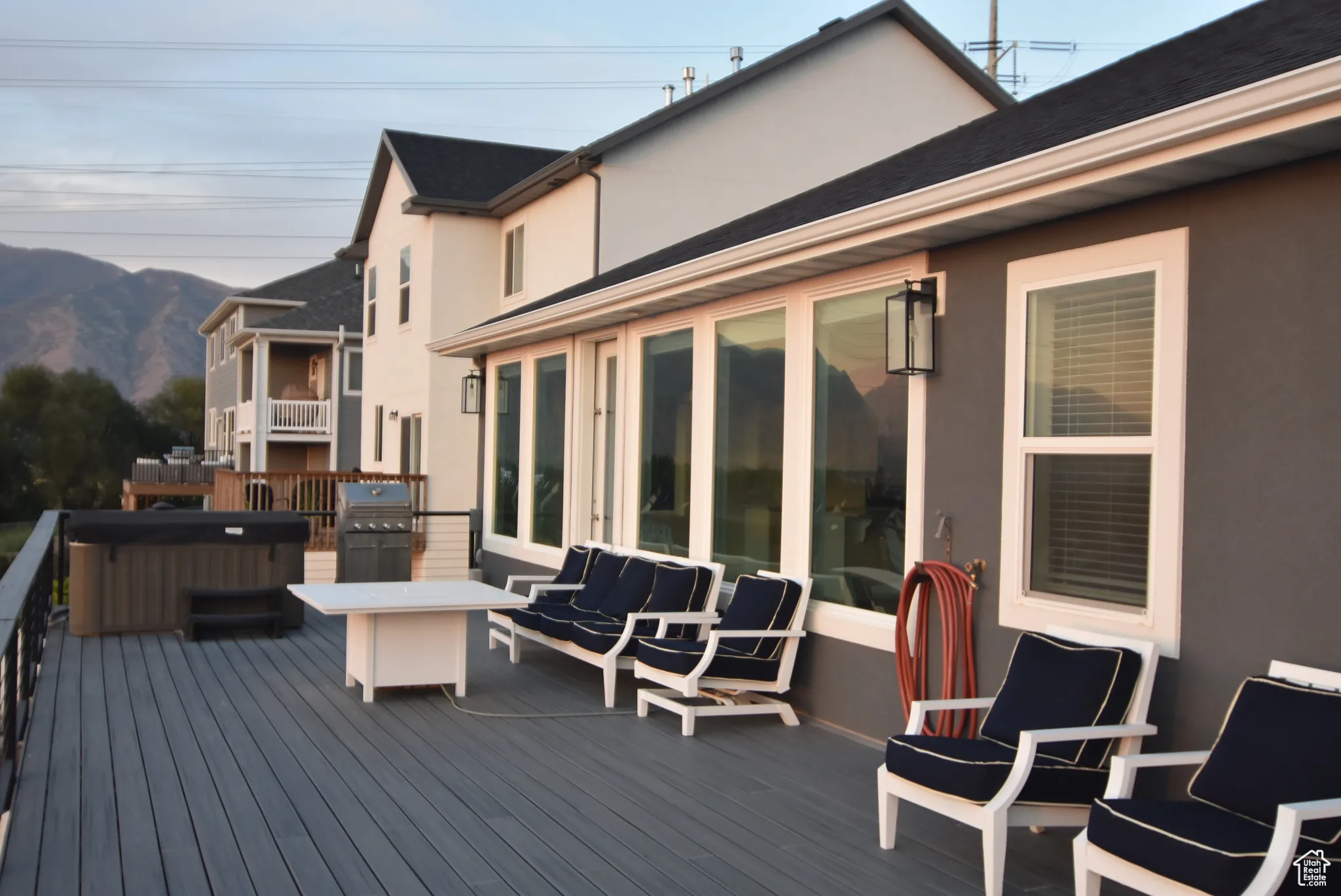 Deck featuring a mountain view, hot tub and natural gas grill
