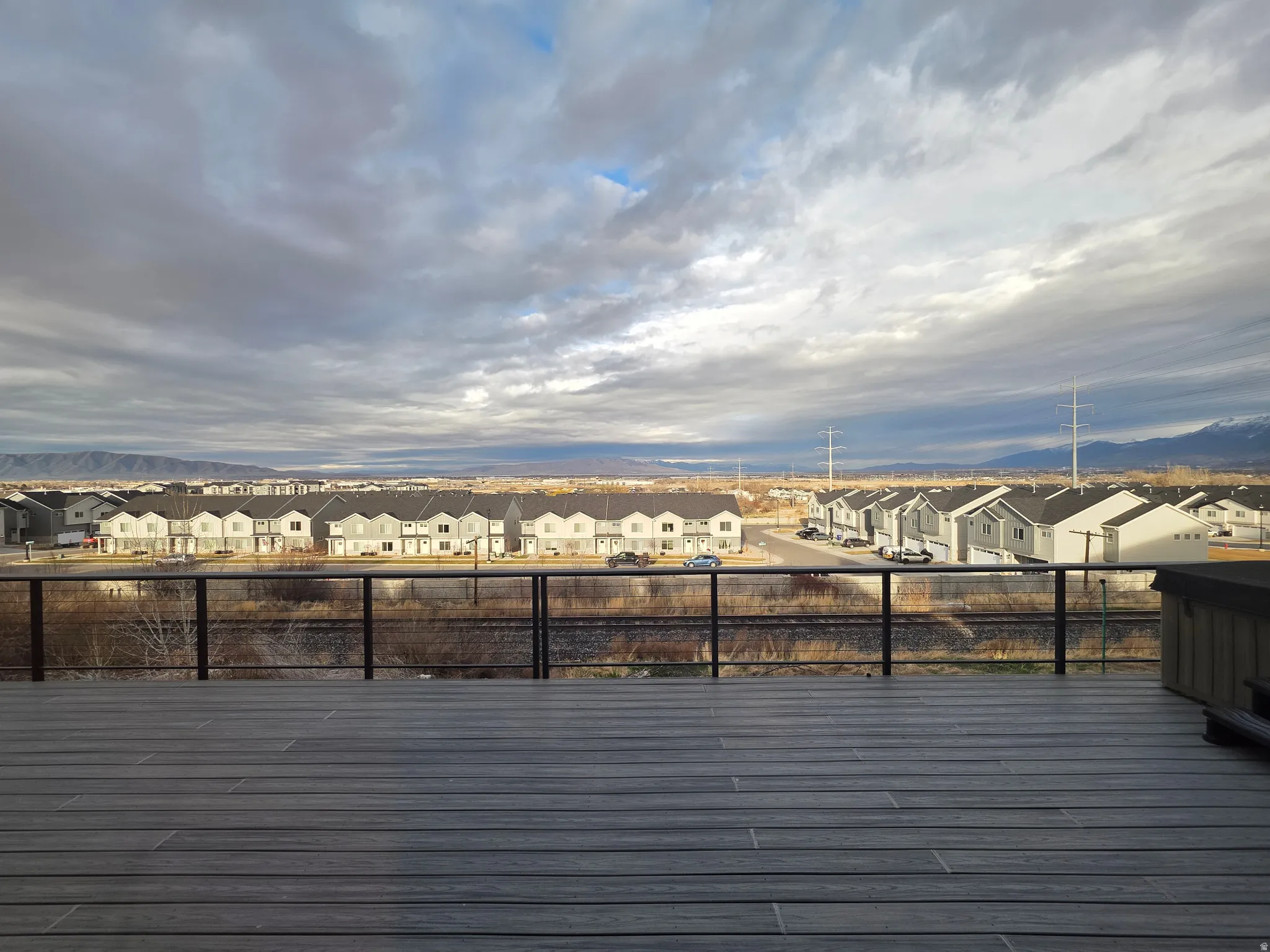 Deck with a residential view and a mountain view