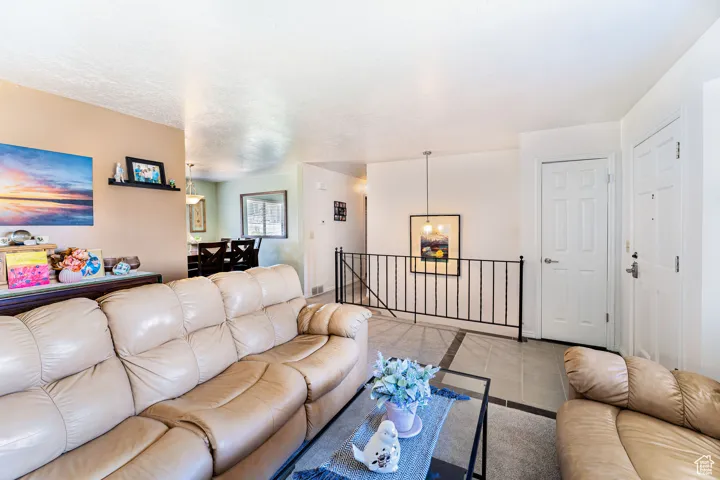Living area with a chandelier and tile patterned flooring