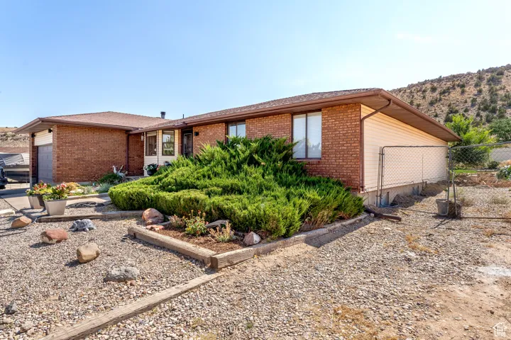 Ranch-style house with brick siding and an attached garage