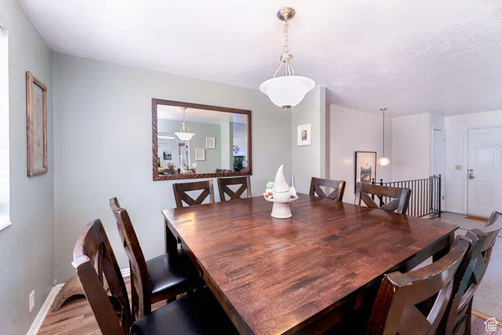 Dining area with wood finished floors and a textured ceiling