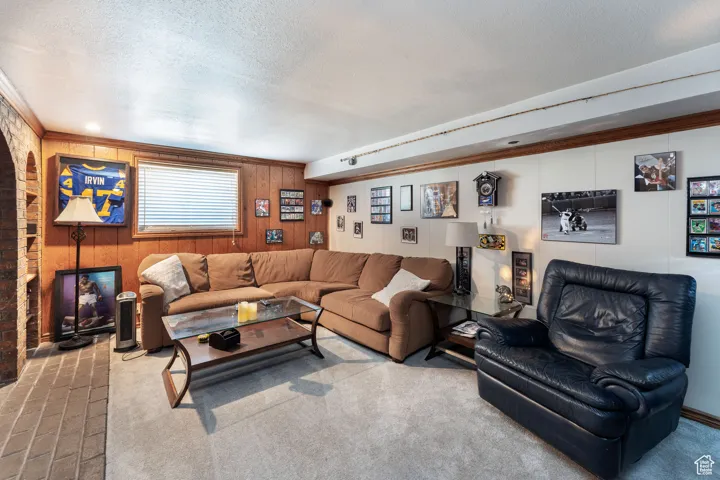 Living area with wood walls and a textured ceiling