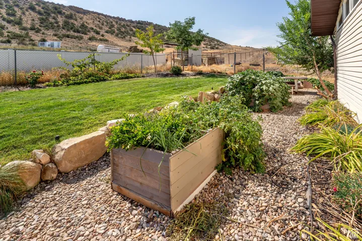 View of yard with a vegetable garden and a mountain view